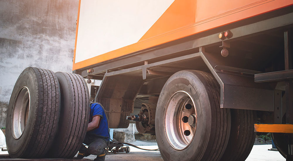 Semi truck repairs on a set of rear tires and wheels