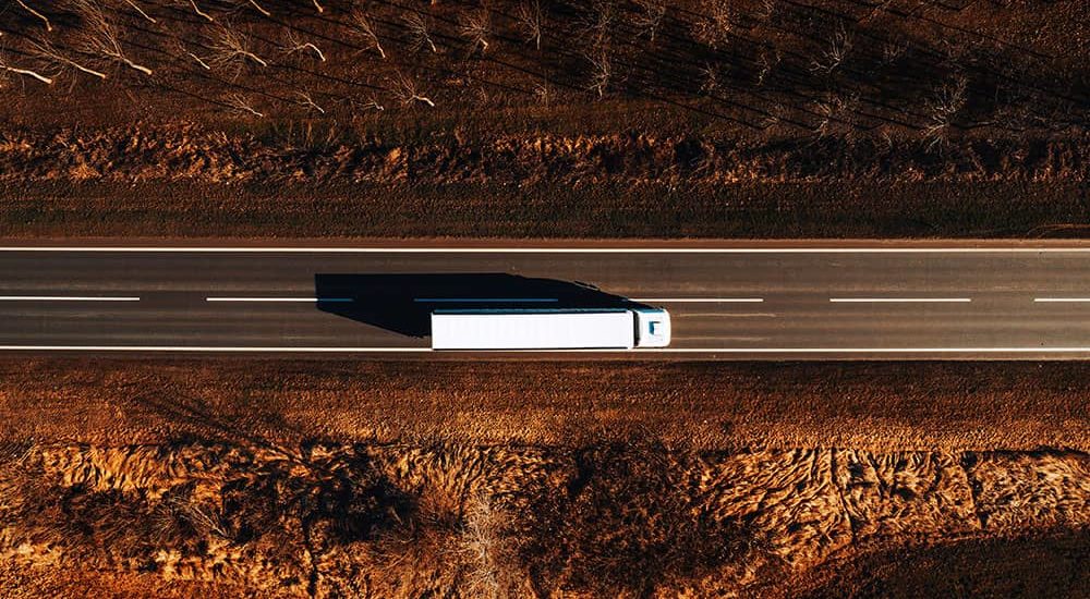 aerial shot of semi driving down a highway